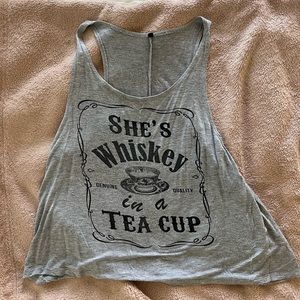 Gray tank top with the phrase “She’s Whiskey In A tea Cup”.